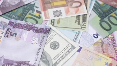 Brezilya vatandaşının uluslararası pasaportu farklı ülkelerin kağıt banknotlarının arka planında
