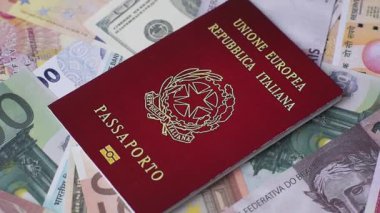 Farklı ülkelerin kağıt banknotlarının arka planında bir İtalyan vatandaşının uluslararası pasaportu