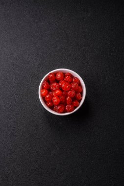 Kurumuş kırmızı kiraz veya koyu beton arka planda şekerli meyveler.