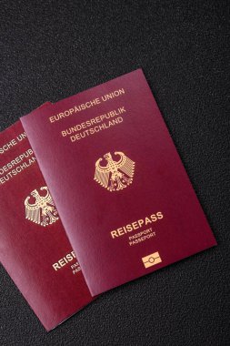 Tasarımınız için bir duvar kağıdı olarak siyah desenli arka plana karşı Alman vatandaşı pasaportu