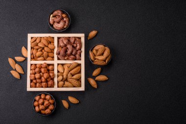 İçinde fındık bademleri, kabuklu bademler, cevizler, fındıklar olan tahta kutu.