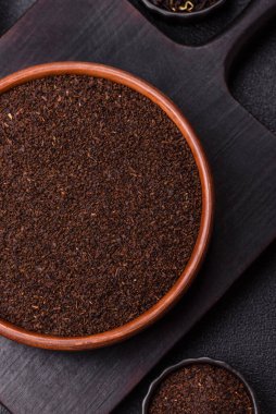 Siyah çay, koyu beton arka planda kasede ezilmiş.