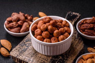 Koyu beton arka planda kabuksuz çiğ fındık.