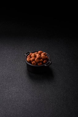 Koyu beton arka planda kabuksuz çiğ fındık.