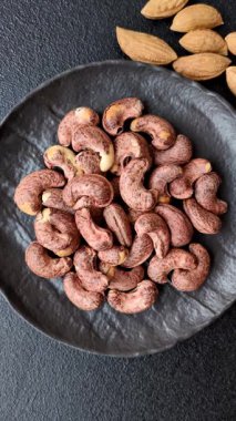 Koyu beton arka planda kabuklu kaju fıstığı.