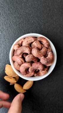 Koyu beton arka planda kabuklu kaju fıstığı.