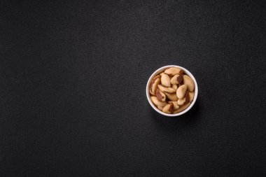 Koyu beton arka planda seramik kasede Brezilya fındık çekirdekleri