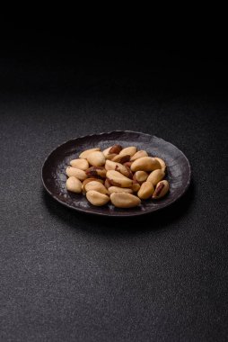 Koyu beton arka planda seramik kasede Brezilya fındık çekirdekleri