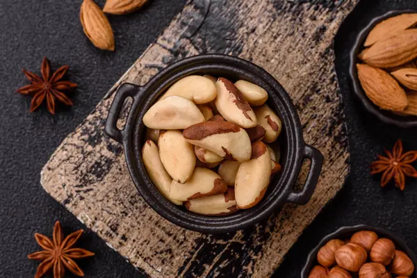 Koyu beton arka planda seramik kasede Brezilya fındık çekirdekleri