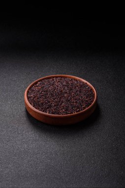 Seramik bir kasede kırmızı veya kahverengi çiğ pirinç. Pirinç Asya organik gıdasının bir malzemesidir.