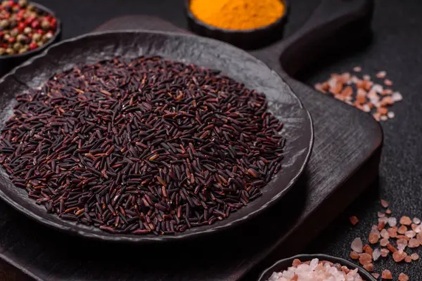 Seramik bir kasede kırmızı veya kahverengi çiğ pirinç. Pirinç Asya organik gıdasının bir malzemesidir.