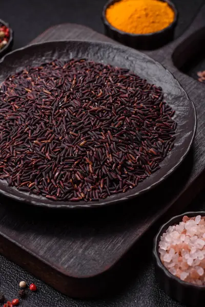 Seramik bir kasede kırmızı veya kahverengi çiğ pirinç. Pirinç Asya organik gıdasının bir malzemesidir.