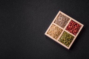 Organik sağlıklı yiyecekler için bir kutu fıstık, sedir fıstığı, ayçiçeği ve balkabağı çekirdeği.