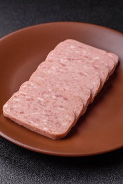 Konserve jambon, et, domuz eti, baharat ve tuzlu, koyu beton arka planda dilimler.