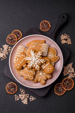 Noel kış zencefilli ekmeği, tek renkli arka planda bayram bisküvileri. Masada zencefilli çörekler