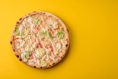 Peynirli ve tavuklu İtalyan sezar pizzası, marul yaprağı ve sos. Fast food, dilimlenmiş pizza.