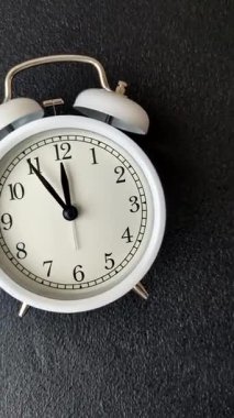 Ofis ve iş yerlerindeki son teslim tarihleri için kavramsal bir arkaplan olarak sarı yüzeyde klasik alarm saati