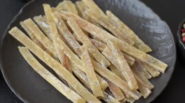 Yiyecek, atıştırmalık ya da kurutulmuş tuzlu balıktan yapılmış baharatlı kurutulmuş et. Atıştırmalıklar balık kuru bira çubukları