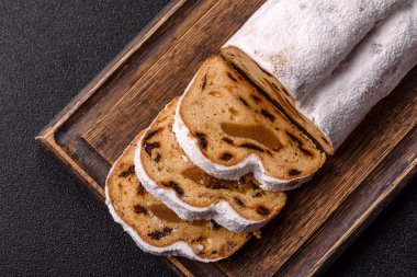 Noel stollen, badem ezmesi ve şekerli meyveli Alman pastası. Şenlik masası için Noel çalıntısı