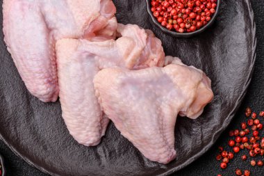 Çiğ tavuk kanatları, pişmemiş taze kümes hayvanları. Tuzlu ve baharatlı tavuk ya da hindi kanadı