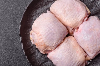 Et, çiğ tavuk budu, tuzlu ve baharatlı deri bacağı. Yemek arkaplanı olarak çiğ tavuk but eti.