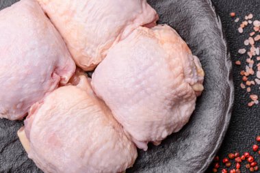 Et, çiğ tavuk budu, tuzlu ve baharatlı deri bacağı. Yemek arkaplanı olarak çiğ tavuk but eti.