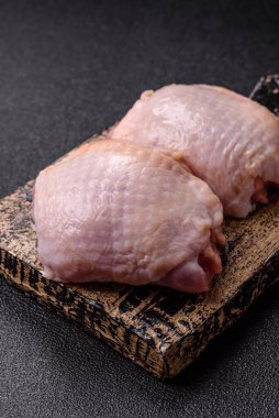 Et, çiğ tavuk budu, tuzlu ve baharatlı deri bacağı. Yemek arkaplanı olarak çiğ tavuk but eti.