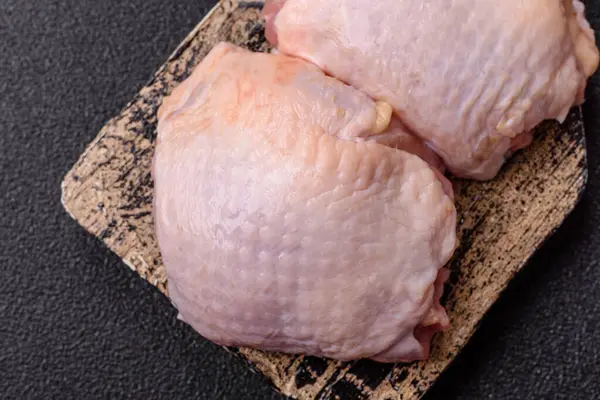 Et, çiğ tavuk budu, tuzlu ve baharatlı deri bacağı. Yemek arkaplanı olarak çiğ tavuk but eti.