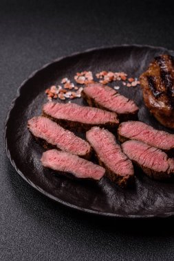 Tuz ve biberli ızgara biftek eti. Biftek ızgarada ızgara. Tasarımın için arka plan olarak.