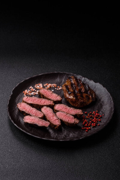 Grilled beef steak meat with salt and pepper. Beef steak grilled on a barbecue as a background for your design