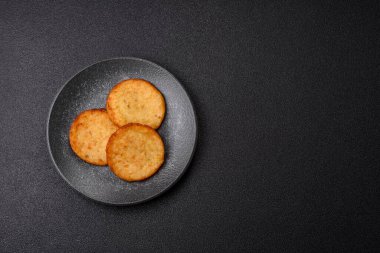 Mücver, patates, soğan ve sebzeden yapılmış kahvaltı yemeği. Koyu beton arka planda patates, tuz ve baharatlı mücver.