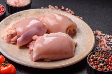 Çiğ tavuk budu fileto derisi ve kemiği olmadan tuz ve baharatla pişirmek için hazırlandı. Evde pişirmek için çiğ tavuk filetosu.