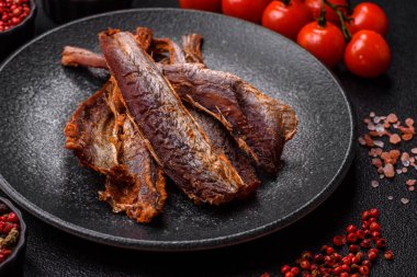 Atıştırmalık olarak kurutulmuş balık veya kurutulmuş et, dilimlenmiş deniz ürünleri. Tasarımınız için arka plan olarak kurutulmuş deniz ürünleri atıştırmalıkları