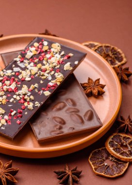 Evde kurutulmuş meyveli çikolatalı bir çikolata. Tasarımınız için arka plan olarak çikolatayı kullanın