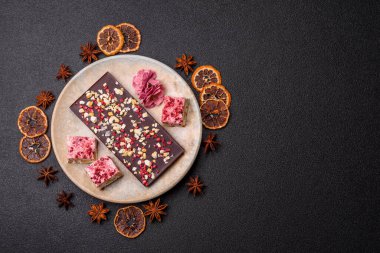 Evde kurutulmuş meyveli çikolatalı bir çikolata. Tasarımınız için arka plan olarak çikolatayı kullanın