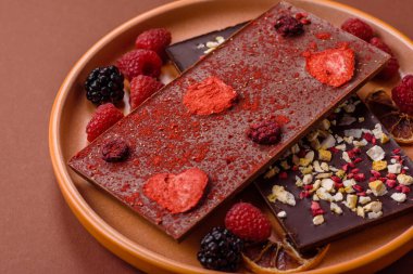 Evde kurutulmuş meyveli çikolatalı bir çikolata. Tasarımınız için arka plan olarak çikolatayı kullanın