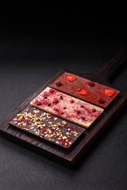 Evde kurutulmuş meyveli çikolatalı bir çikolata. Tasarımınız için arka plan olarak çikolatayı kullanın