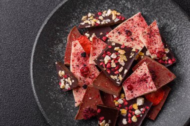 Evde kurutulmuş meyveli çikolatalı bir çikolata. Tasarımınız için arka plan olarak çikolatayı kullanın