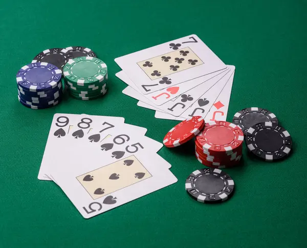 Kumarhanede poker oynuyorum. Fişler, bahisler ve risklerle. Yeşil kartlar ve çipler tasarımınız için arka plan görevi görür