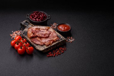 Lezzetli bir İngiliz kahvaltısının malzemesi olarak kızarmış domuz pastırması. Tasarımın için arka plan olarak kızarmış pastırma parçaları.