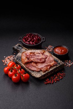 Lezzetli bir İngiliz kahvaltısının malzemesi olarak kızarmış domuz pastırması. Tasarımın için arka plan olarak kızarmış pastırma parçaları.