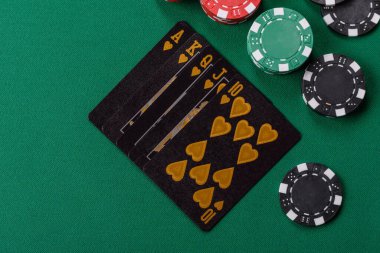 Kumarhanede poker oynuyorum. Fişler, bahisler ve risklerle. Yeşil kartlar ve çipler tasarımınız için arka plan görevi görür