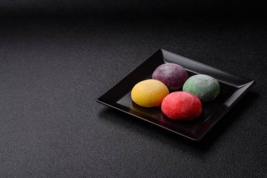 Japon mochi, dondurma ya da meyveli pirinç unundan yapılmış Asya tatlısı. Farklı renklerde mochi ve yiyecek arka planı olarak meyve dolgu