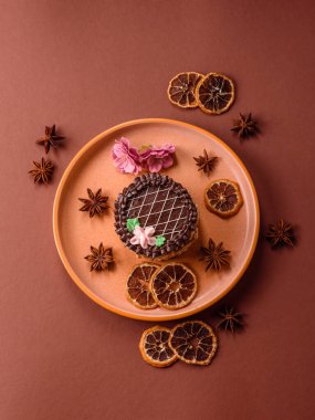 Tatlı tart, çikolatalı turta ve tabakta meyveli krema. Festival masası için çikolatalı tart tatlısı.