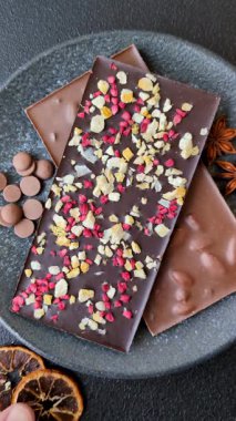 Evde kurutulmuş meyveli çikolatalı bir çikolata. Tasarımınız için arka plan olarak çikolatayı kullanın