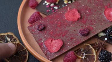 Evde kurutulmuş meyveli çikolatalı bir çikolata. Tasarımınız için arka plan olarak çikolatayı kullanın