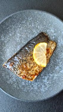 Yiyecek, deniz ürünleri, limon, tuz ve baharatlı ızgara balık filetosu. Öğle yemeği için ızgara balık filetosu, sağlıklı yemek.