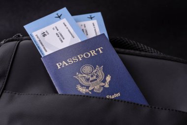 Amerikan pasaportu, seyahat için Amerikan vizesi, seyahat çantasındaki biletlerle dolu belgeler. Tasarımınız için arka plan olarak ABD pasaportu