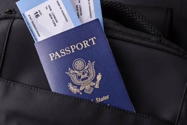 Amerikan pasaportu, seyahat için Amerikan vizesi, seyahat çantasındaki biletlerle dolu belgeler. Tasarımınız için arka plan olarak ABD pasaportu