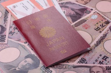 Japanese passport or id document with tickets for flight, travel, border crossing. Japan passport and tickets as a background for your design